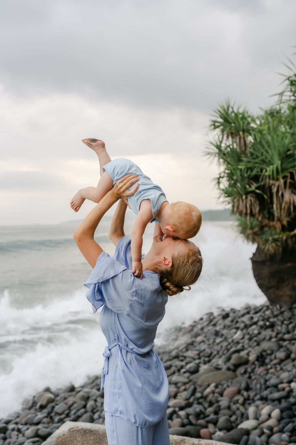 Charlene Rennit lifting Rumi by the ocean in Bali