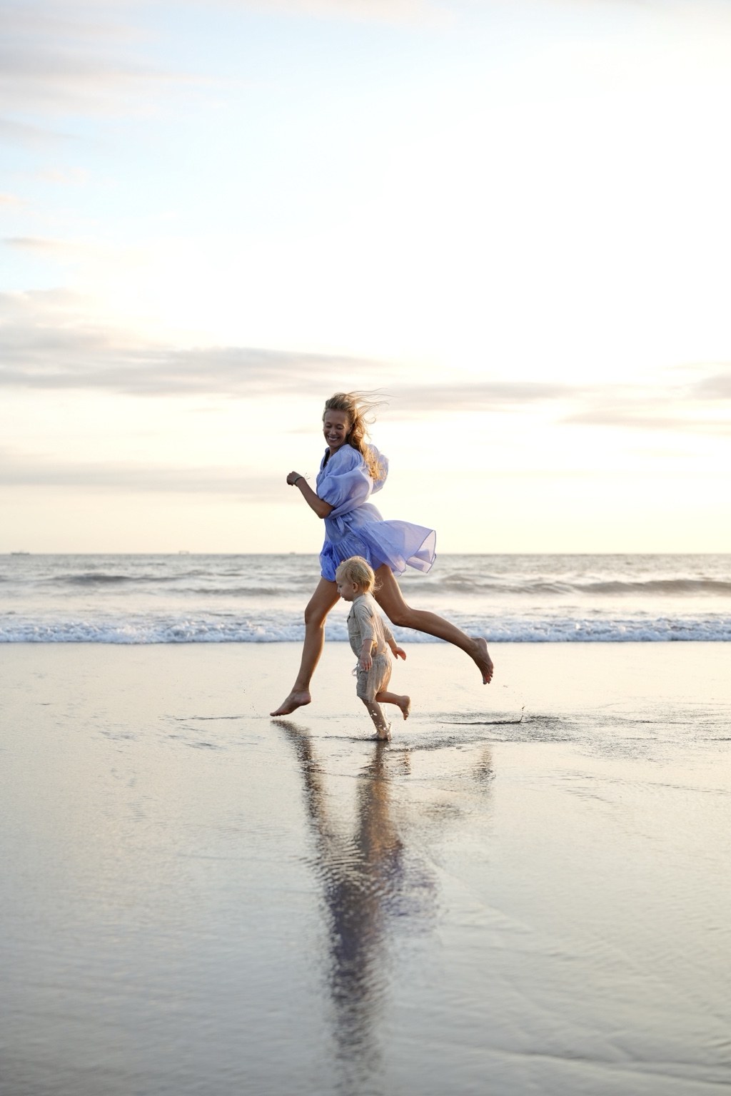 Charlene Rennit and Rumi running together on the beach