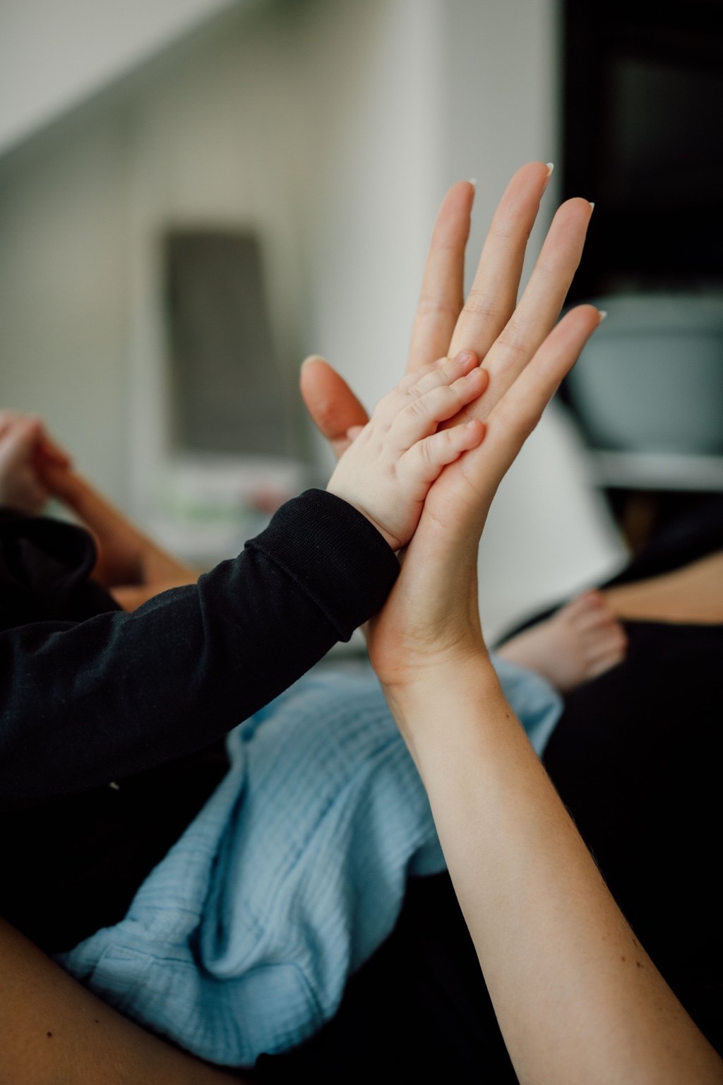 Rumi's hand resting on Charlene Rennit's hand
