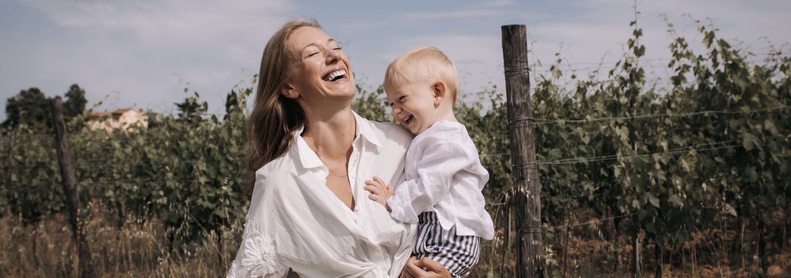 Charlene Rennit laughing with her son Rumi outdoors
